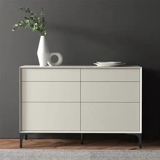 Modern light grey sideboard with a vase and plates on top against a dark grey wall.