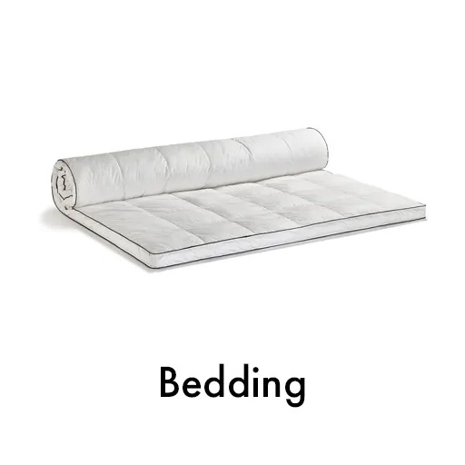 A white mattress topper placed on a white surface, creating a seamless and clean aesthetic