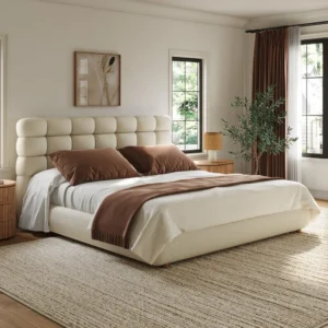 Lunara Bouclé Bed with box-tufted headboard and minimalist wooden legs styled in modern bedroom