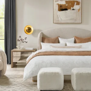 Light beige upholstered bed with curved headboard, wooden base accent, and minimalist styling.