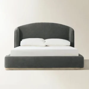 Dark grey upholstered bed with tall curved headboard, white bedding, and minimalist platform base.