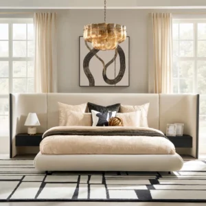 Beige upholstered bed with extended headboard and built-in black nightstands in a minimalist bedroom.